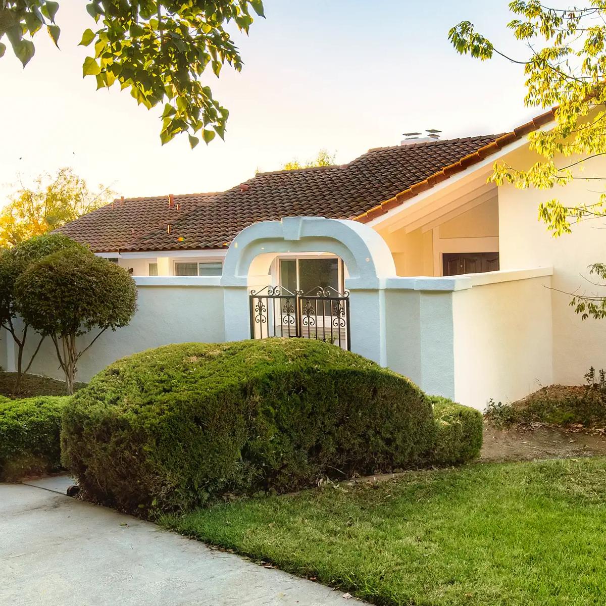 The front entry gate of one of Chris and Kayvan's past listings, golden hour light