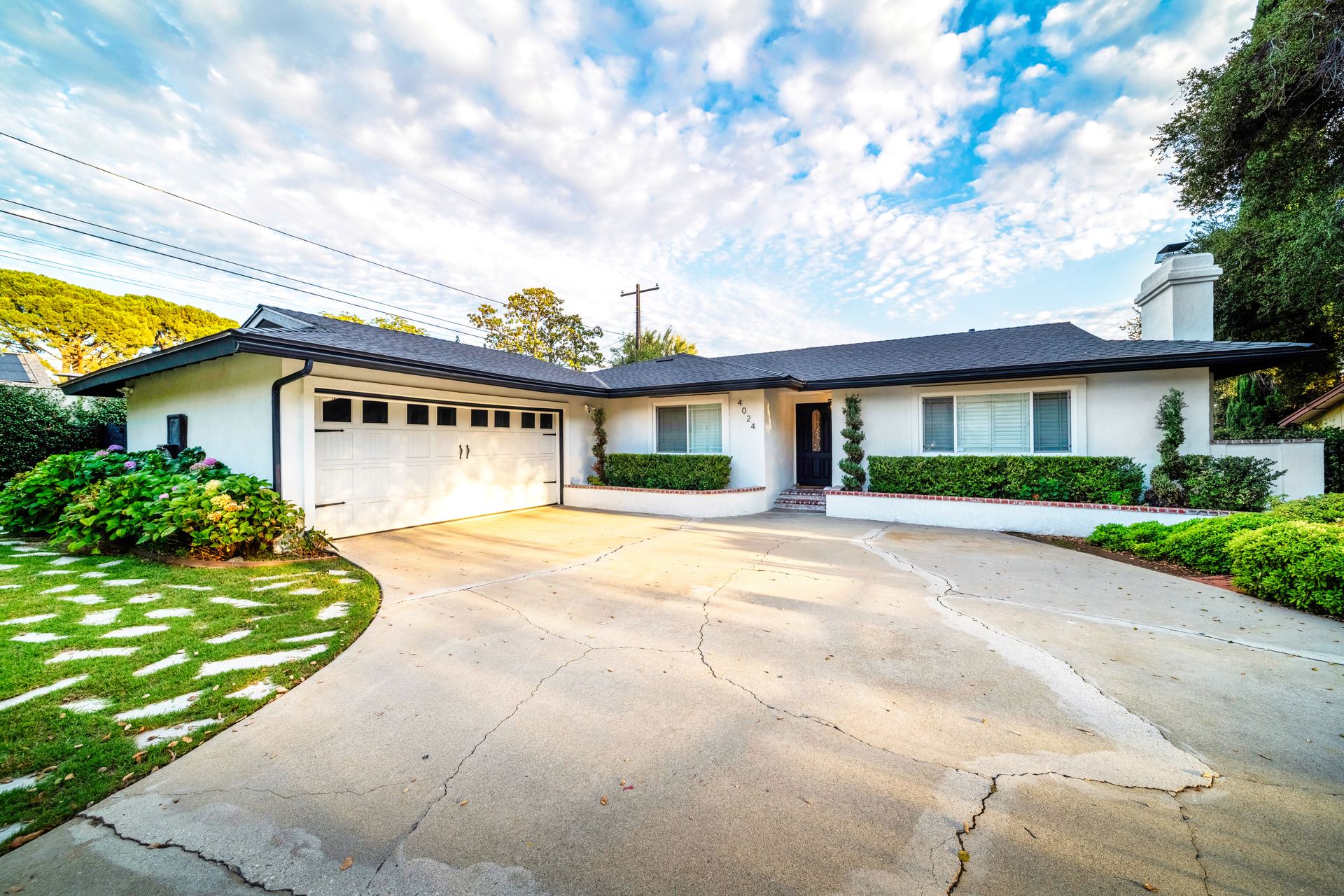 Single-story ranch home at 4024 N Williams Ave, Claremont, with a wide front lawn and long private driveway
